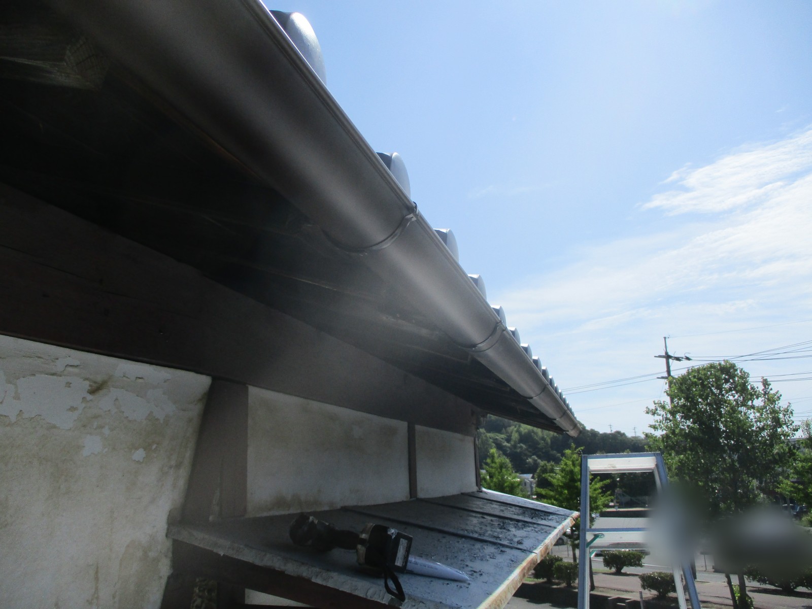 軒先にそって一直線に続く新しい雨樋を見上げた様子